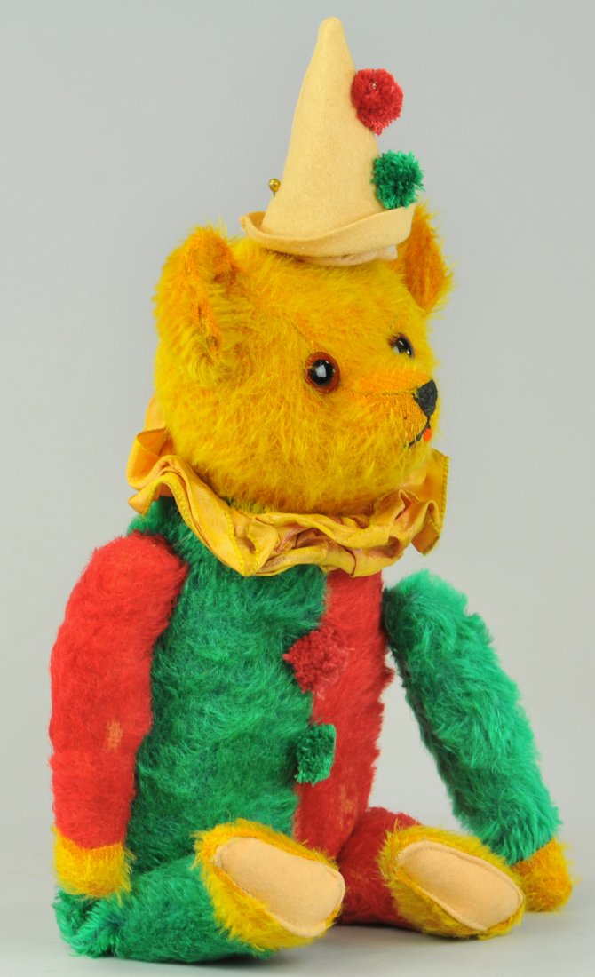 CLOWN TEDDY BEAR WITH MUSICAL BELLOWS: c. 1920's, German, very rare & unusual colorful bear with felt hat, squeeze mechanism that produces music, working bellows. 16" h.