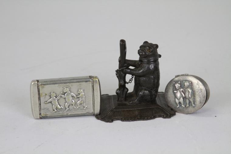 THREE BEAR NOVELTY ITEMS: Nice grouping of bear theme items, includes match safe with embossed bears, scarce Roosevelt Teddy pill box with bear emblems, and bear match stick holder. 2" - 3" l.