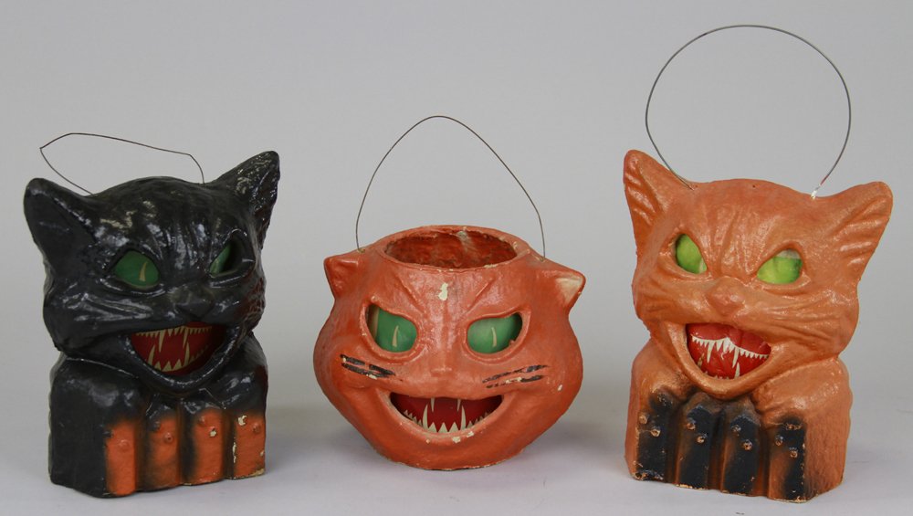 THREE PULP HALLOWEEN JACK-O-LANTERNS: Includes black cat on fence, orange cat on fence, and black whisker cat lantern; all with paper insert faces. 5 1/2" - 7 1/2".