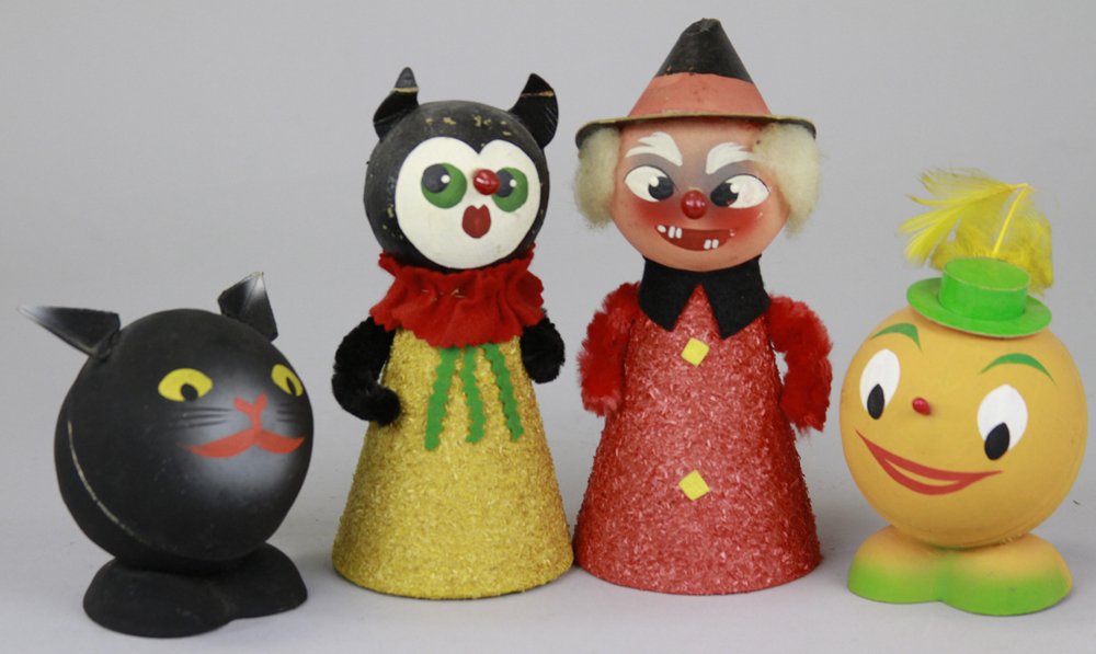 GROUPING OF FOUR HALLOWEEN CANDY CONTAINERS: Western Germany, includes a smiling black cat, pumpkin man, both open at the back of head, along with witch & black cat, both open at base. 4" - 7".