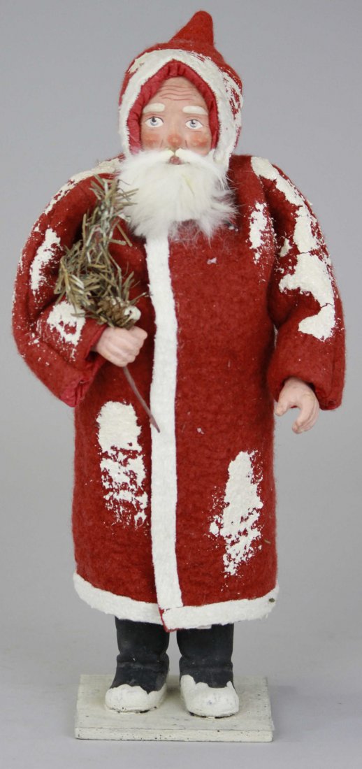FATHER CHRISTMAS CANDY CONTAINER: Germany, red robe flecked with snow, white trim, composition face & hands, rabbit fur beard, holding paper tree spring, separates at base for candy retrieval. 13" h.