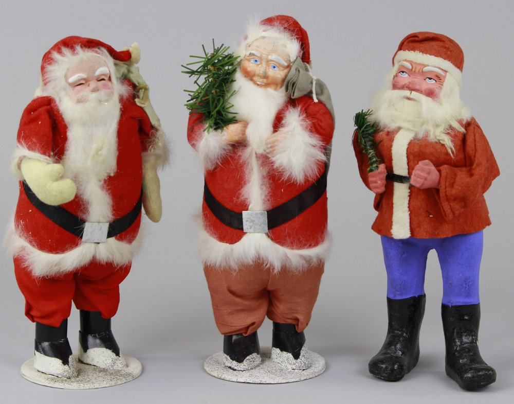 GERMAN SANTA CANDY CONTAINER & TWO SANTAS: German, Santa in red short coat w/white trim, blue composition pants, composition face w/rabbit fur beard, and two "Made in Japan" Santa's. 9" - 10" h.