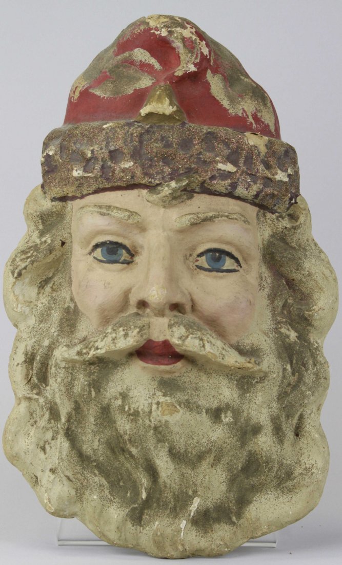 EARLY COMPOSITION SANTA CLAUS HEAD: Germany, large German pressed and formed Santa's head, blue eyes and strong features throughout, shows some eye wear and some loss to finish. 19" l.