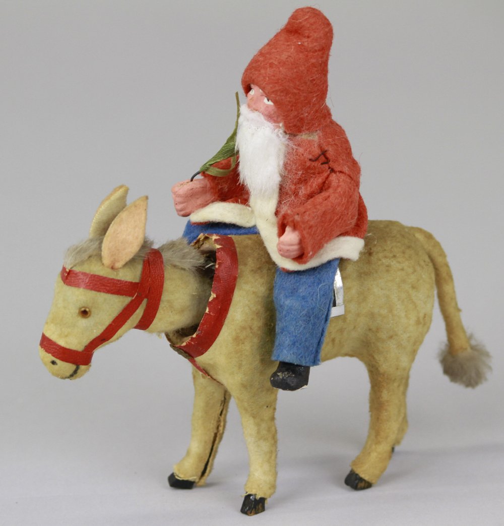SANTA ON DONKEY NODDER: Germany, Santa in red coat trimmed w/white, blue pants, rabbit fur beard, riding donkey nodder. Donkey trimmed in red, glass eyes, fur mane with fur tufted tail, standing on black hoof, wooden legs. 5