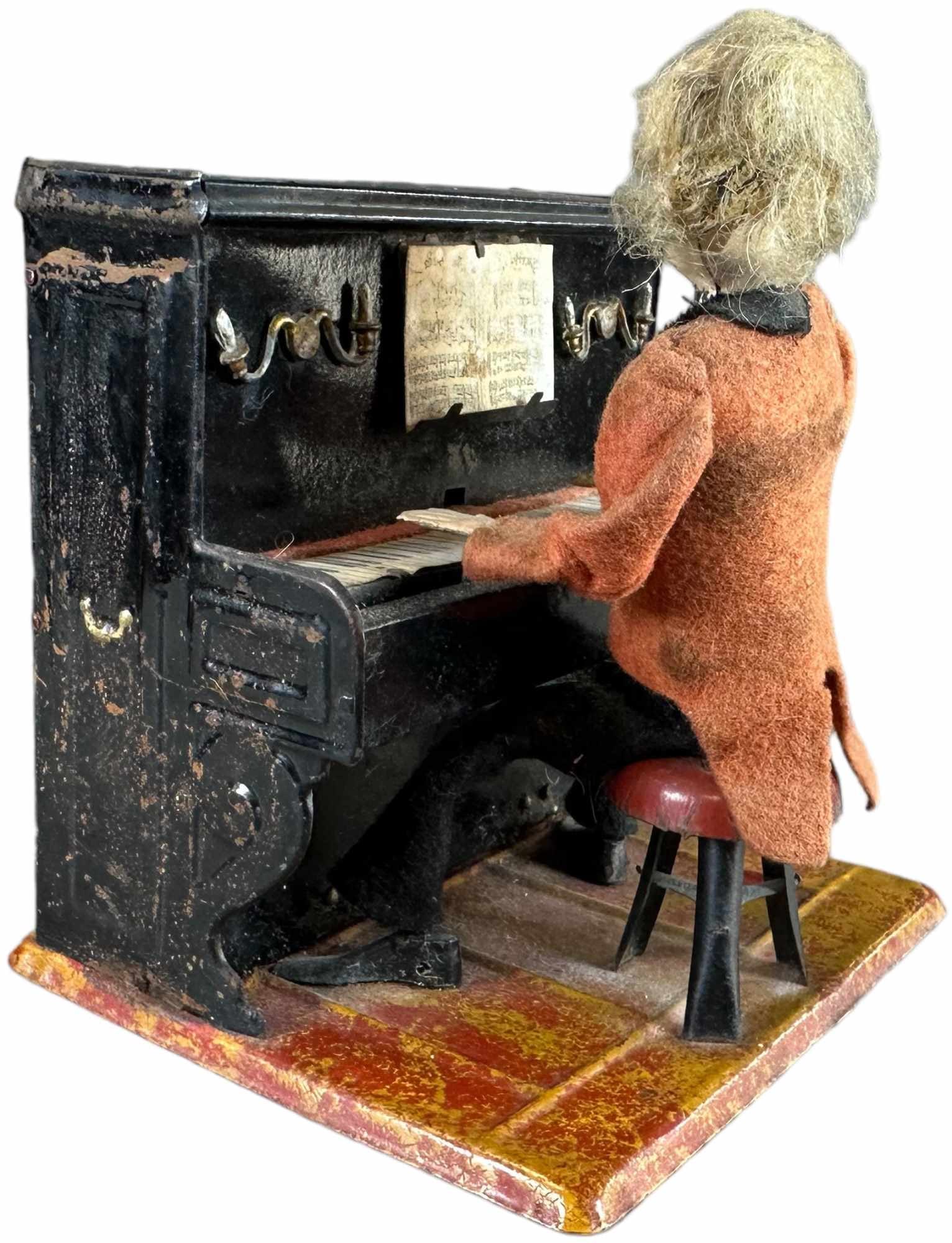 FERNAND MARTIN THE PIANIST: 165. FERNAND MARTIN THE PIANIST | France, "Le Petit Pianiste," circa 1902, wind-up mechanism causes the man to sway back and forth while touching keys, the piano actually emits a chime music. | 6.5" h