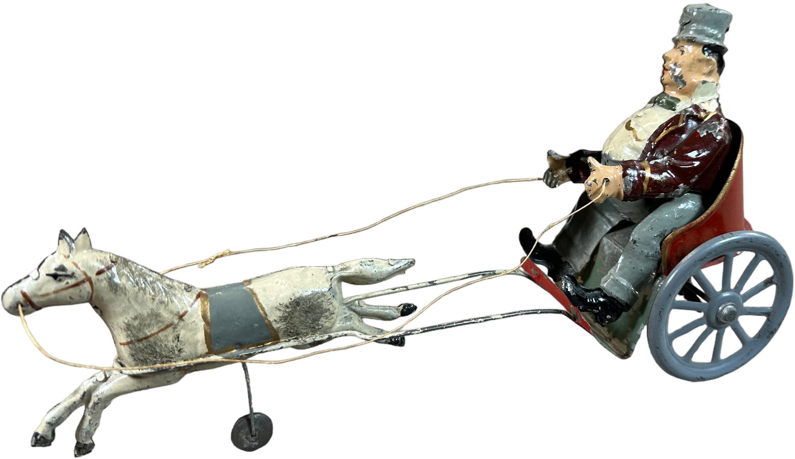 ROTUND MAN IN PONY CHARIOT: 192. ROTUND MAN IN PONY CHARIOT | Germany, wind-up mechanism, hand painted example. | 12" l. | Paint has some flaking but is all original, working in (Excellent Condition) | $500 - $750