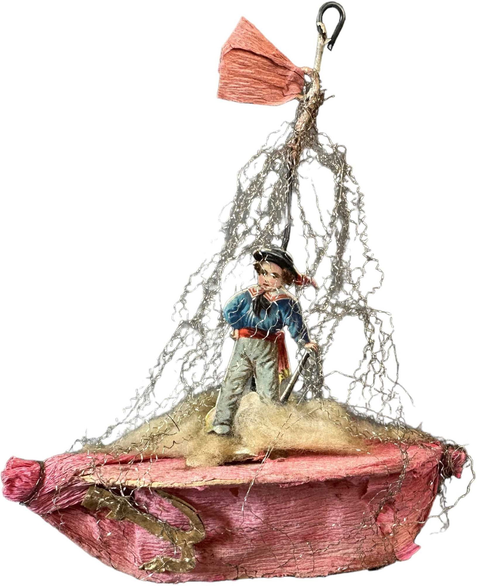 CREPE PAPER SAILBOAT ORNAMENT: 1085. CREPE PAPER SAILBOAT ORNAMENT | Crepe paper, wire and cotton pink sailboat with anchor, wire mast, pink flag and sailor boy. | 4" h. | Overall (Excellent Condition) | $300 - $400