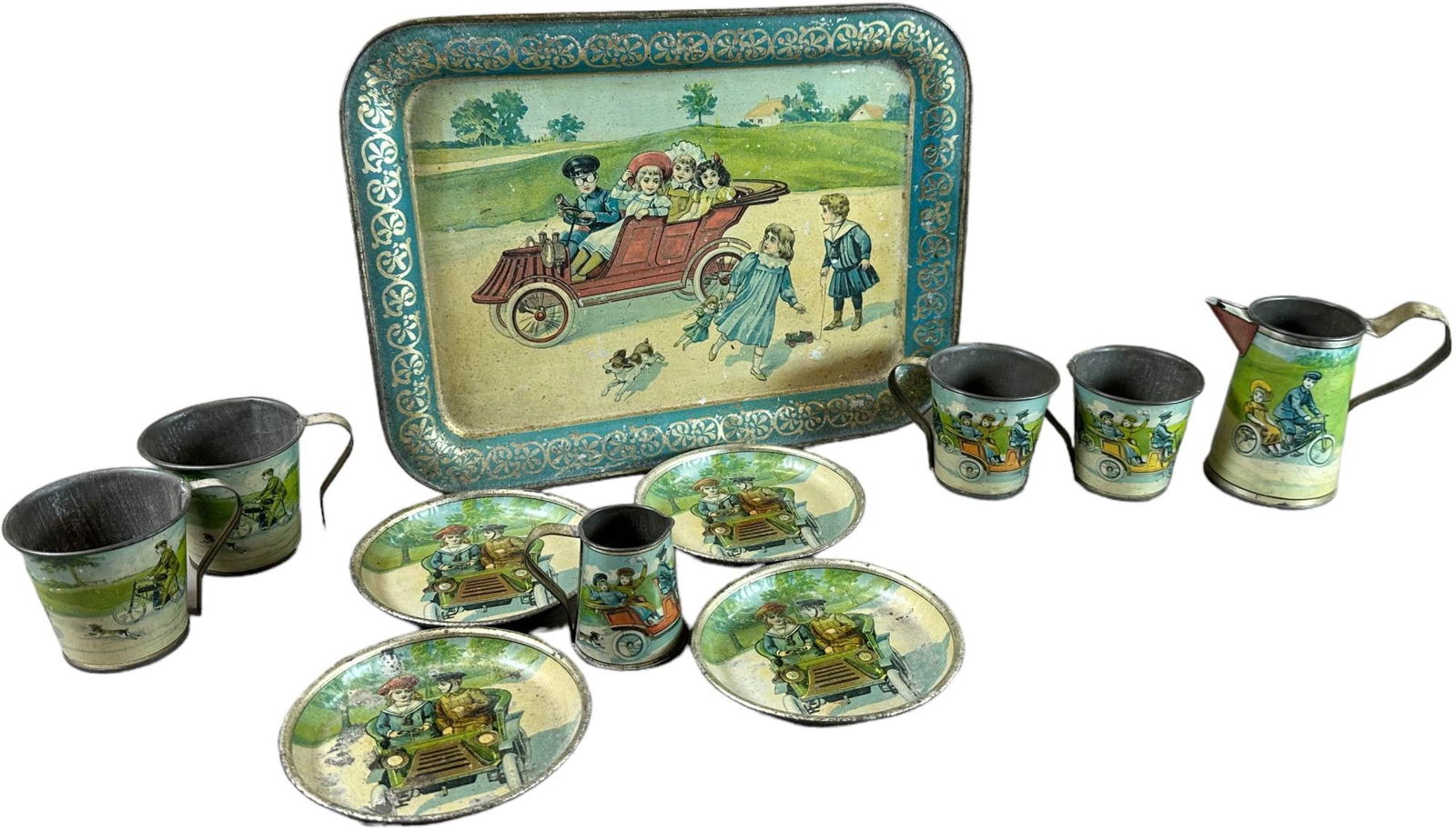 EARLY AUTOMOTIVE LITHOGRAPH CHILDS TEA SET: 1161. EARLY AUTOMOTIVE LITHOGRAPH CHILDS TEA SET | includes 4 tea cups, 4 plates, creamer, pitcher and tray. | 11" l. tray | (Excellent to Pristine Condition) | $500 - $750