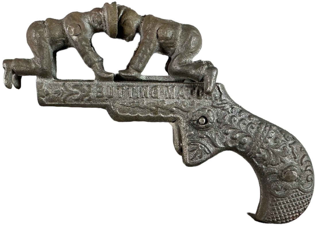 IVES BUTTING MATCH ANIMATED CAP GUN: 1331. IVES BUTTING MATCH ANIMATED CAP GUN | Action is two boys butting heads. | 5" l. | (Very Good Condition) | $300 - $500