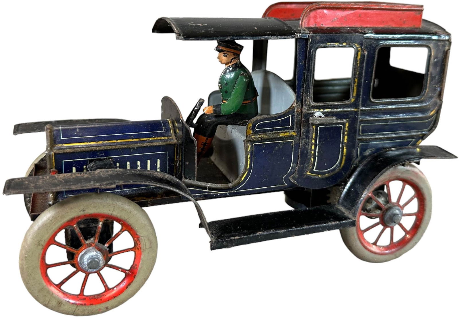 SMALL GERMAN TIN LIMOUSINE: 340. SMALL GERMAN TIN LIMOUSINE | German, circa 1930s, wind-up driven, lithographed tin. | Provenance: The John & Adrianne Haley Collection. | 7.5" l. | Missing steering wheel and one of driver's arms