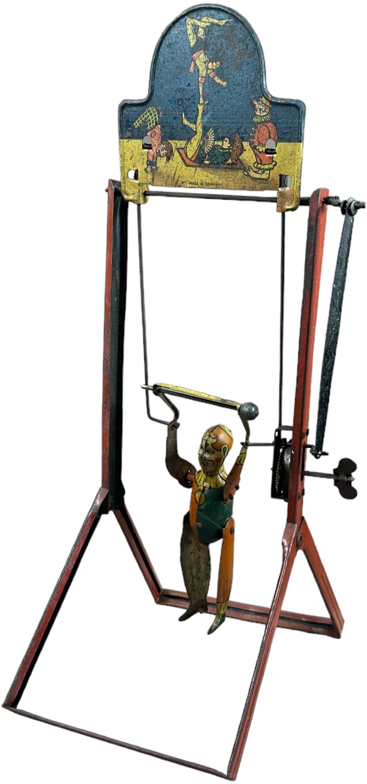 EBO ACROBATIC GYMNAST ON RINGS: 285.EBO ACROBATIC GYMNAST ON RINGS | The Hans Eberl clown logo can faintly be seen on the marquee. | 14" h. | Slight bend to toy causes wind-up action to get stuck at time, wind-up is working and toy