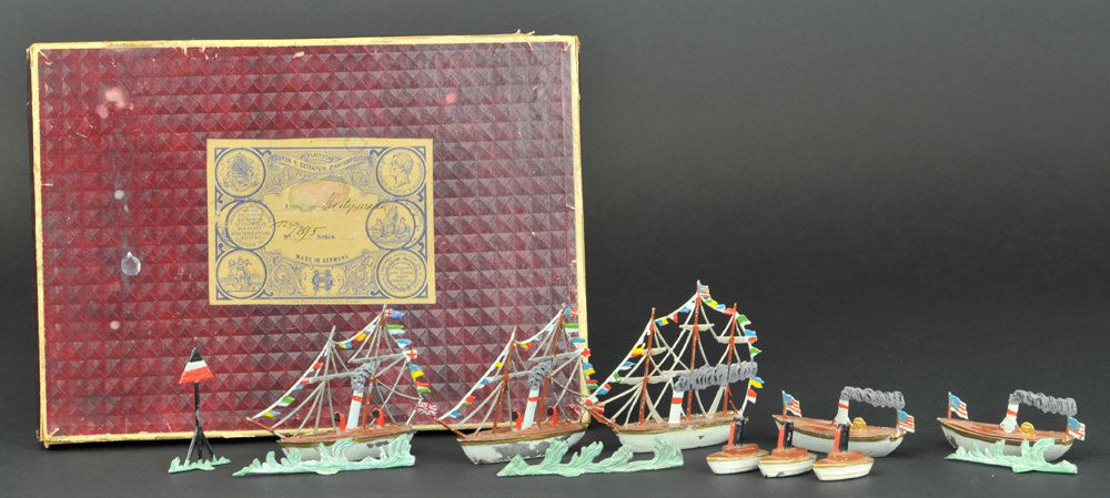 HEYDE BOXED TOY BOAT SET: Germany, circa 1900, hand painted set includes steamers, three with full rigging, together with assorted vessels, wave castings and nautical standing sign, billed as the American Fleet Parade, very co