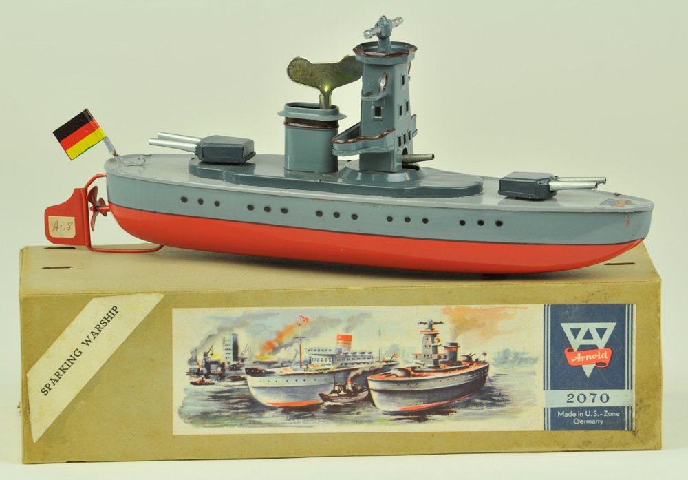 ARNOLD BOXED BATTLESHIP: U.S. Zone, Germany, #2070, circa 1950's, lithographed tin, done in red and grey hull, dark grey upper deck appointments, features cannons at observation tower, key wind driven. 10" l.