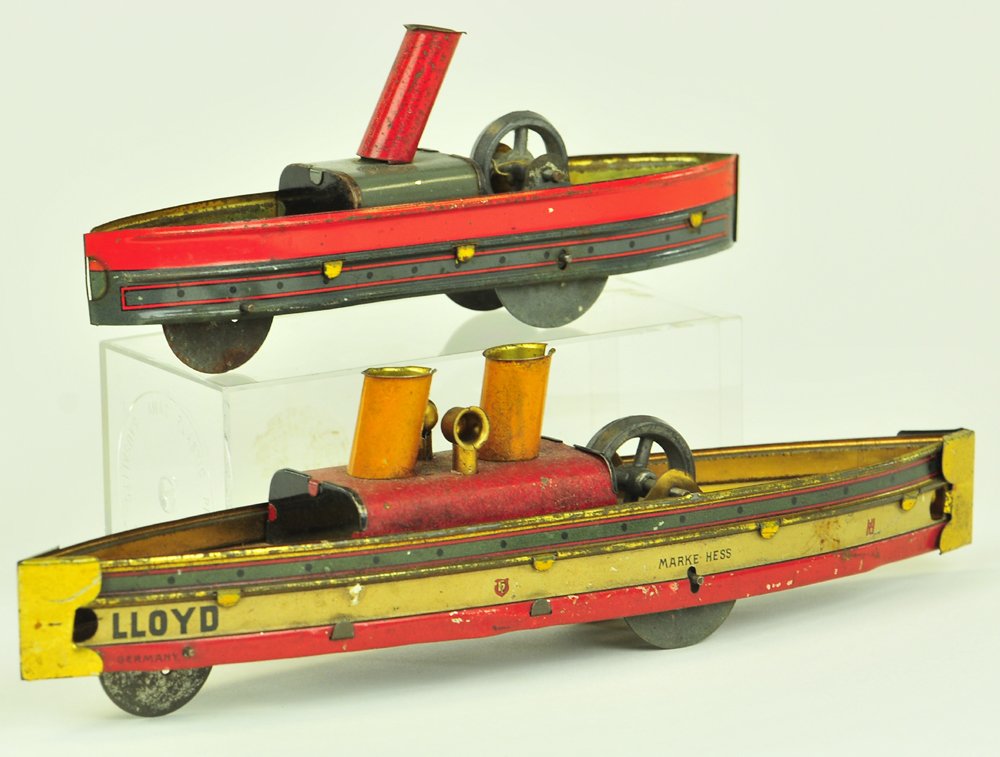 LOT OF TWO HESS LAUNCHES: Both lithographed tin, very colorful, one features single stack, other has two stacks, each with flywheel on deck. 6 3/4" & 9 1/2". 9 1/2" l.