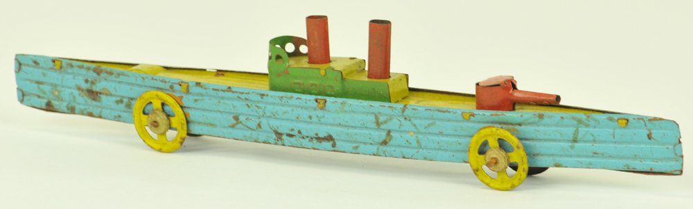 FISCHER GUNBOAT PENNY TOY: Germany, lithographed tin, long example with nice color scheme of hull and yellow deck, guns appear at bow and stern, cabin complete with two lifeboats, spoke wheels. 9 1/2" l.