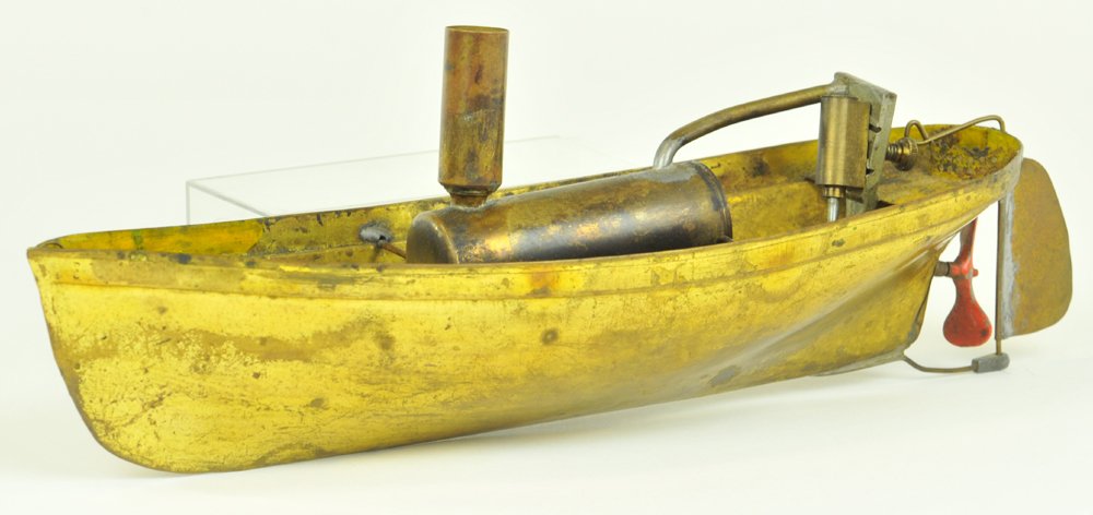 UNION MFG. RIVER BOAT: circa 1850-1870, hand painted tin, open hull, perforated stern cover painted in yellow, steam powered, tin covered stern, one of the earlier of steam boat toys. 18" l.