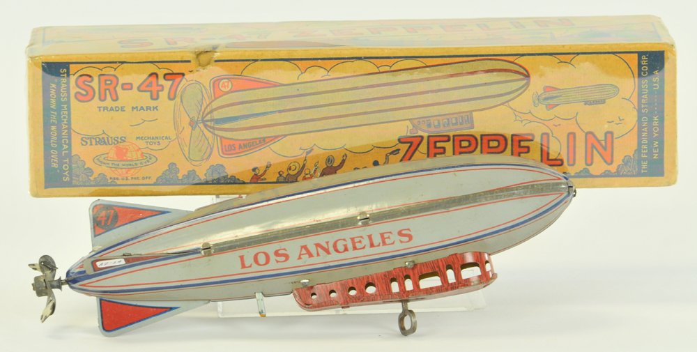 BOXED "LOS ANGELES" ZEPPELIN: Strauss, lithographed tin in light grey, reads "Los Angeles" on sides, celluloid prop missing, clockwork mechanism under gondola, nice action. 9 1/2" l.