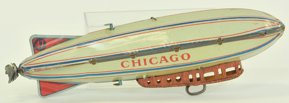 "CHICAGO" ZEPPELIN: Strauss, lithographed tin, reads "Chicago" on sides, clockwork driven, gondola has die-cut windows, some flaking at one end, on/off switch at top of toy. 9 1/2" l.