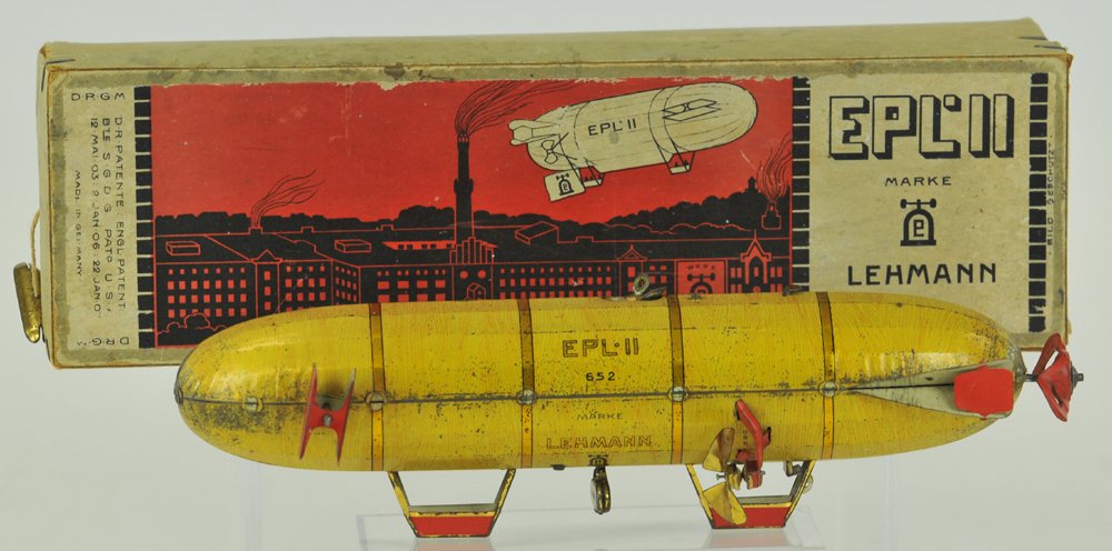 LEHMANN "EPL II" DIRIGIBLE WITH BOX: Germany, lithographed tin, celluloid propellers are clockwork driven, works by suspending strings to allow travel, red tin side blades and props, lettered in gold colors. 9" l.