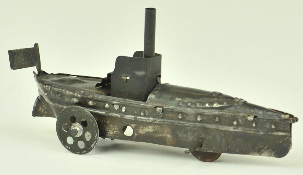 TORPEDO BOAT PENNY TOY: Germany, Distler, painted in black overall, periscope appears at conn, three wheels, stairs lead to platform. 4 3/4" l.