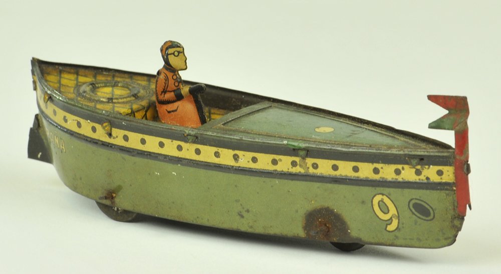 PAYA SPEED BOAT PENNY TOY: Spain, lithographed tin, features seated driver, done in green hull, flag at bow, three wheels. 5" l.