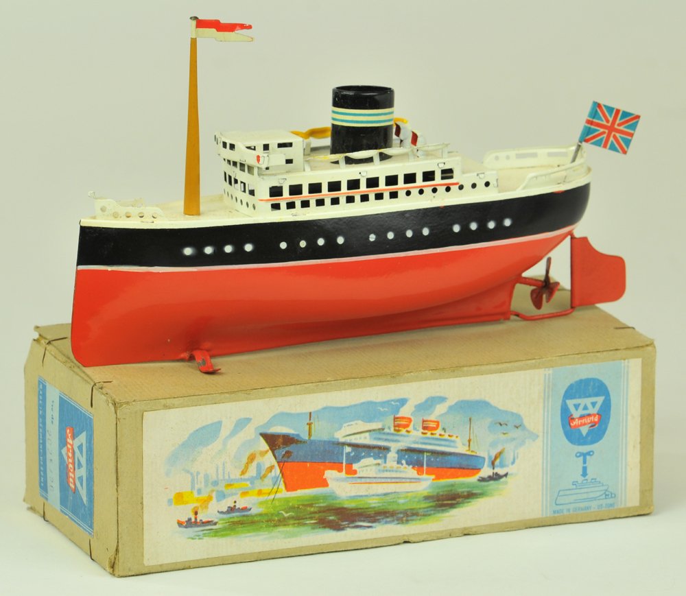 ARNOLD LINER WITH BOX: Germany, c. 1950, 2025/20, lithographed tin, red and black hull, white cabin, single black funnel and mast, clockwork powered, deck contains rows of lifeboats, box has colorful paper lid graphics. 7 1