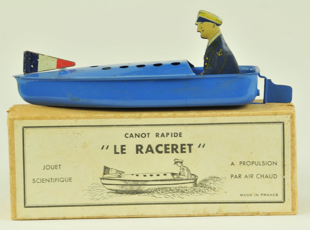 "LE RACERET" SPEEDBOAT IN BOX: France, propulsion boat with seated driver, tin hull done in blue overall, spirit burner fits in base of hull, flag at bow, another interesting "scientific" branded toy boat. 6" l.