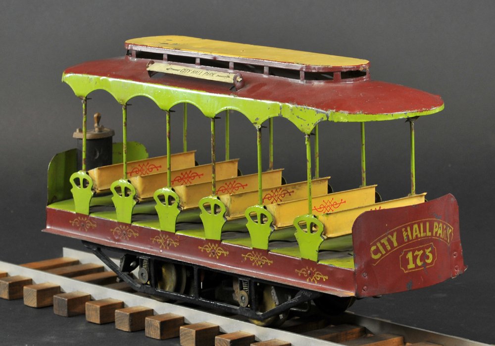 LIONEL 2 7/8" GAUGE, "CITY HALL PARK" TROLLEY: Very rare, #300, circa 1902, Lionel had these earlier trolleys pressed by Converse, large scale, pressed steel, bench seating is reversible, early example done in green, tan, and brown, wooden floor, 