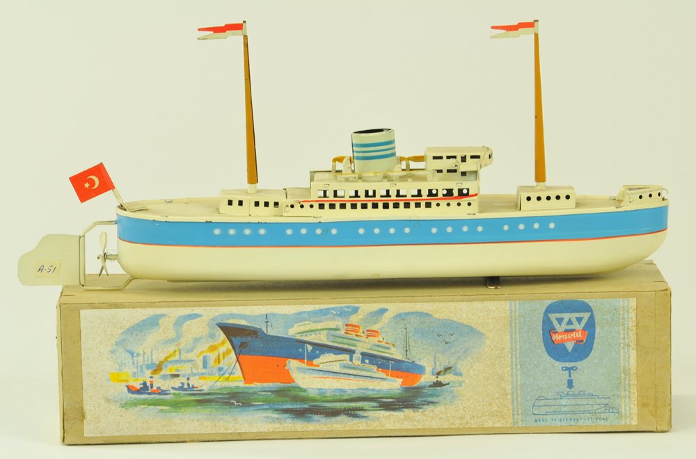 ARNOLD LINER WITH BOX: Germany, #2020/30, circa 1950's, lithographed tin, done in white overall, blue band hull, features upper deck cabin, single stack, two masts, and rows of lifeboats, key wind driven. 11" l.