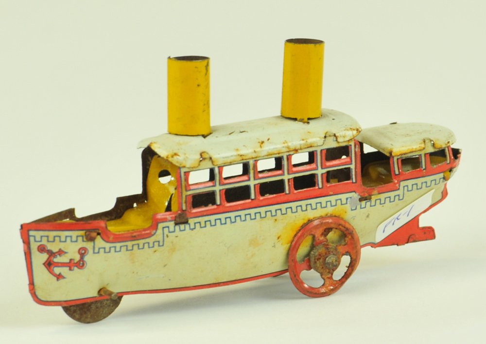 PASSENGER BOAT PENNY TOY: Fischer, Germany, lithographed tin, done in white overall, two yellow stacks, red spoke wheels. 4 1/4" l.