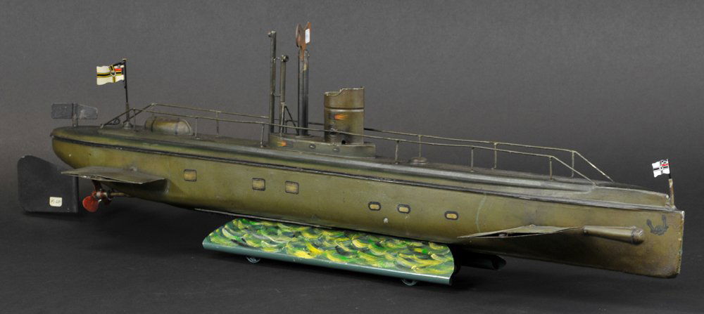 MARKLIN SUBMARINE: Germany, #5084/76, longest example in the dive series of submarines by Marklin, stealthy olive green overall, deck fully railed conn tower on black platform, fixed periscope, lifeboat attached to deck