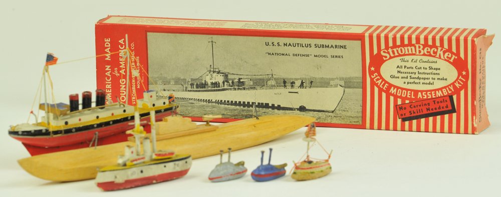 WOODEN TOY BOAT GROUPING: Assorted lot includes: Boxed "U.S.S. Nautilus" Submarine by Strombecker, together with several wood and composition Japanese made ships, including "Queen Mary" and others in smaller scale. 1 3/4" - 11