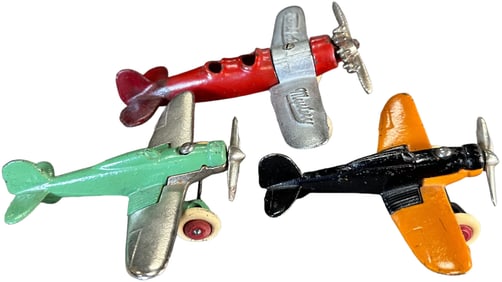 THREE COLORFUL CAST IRON AIRPLANES