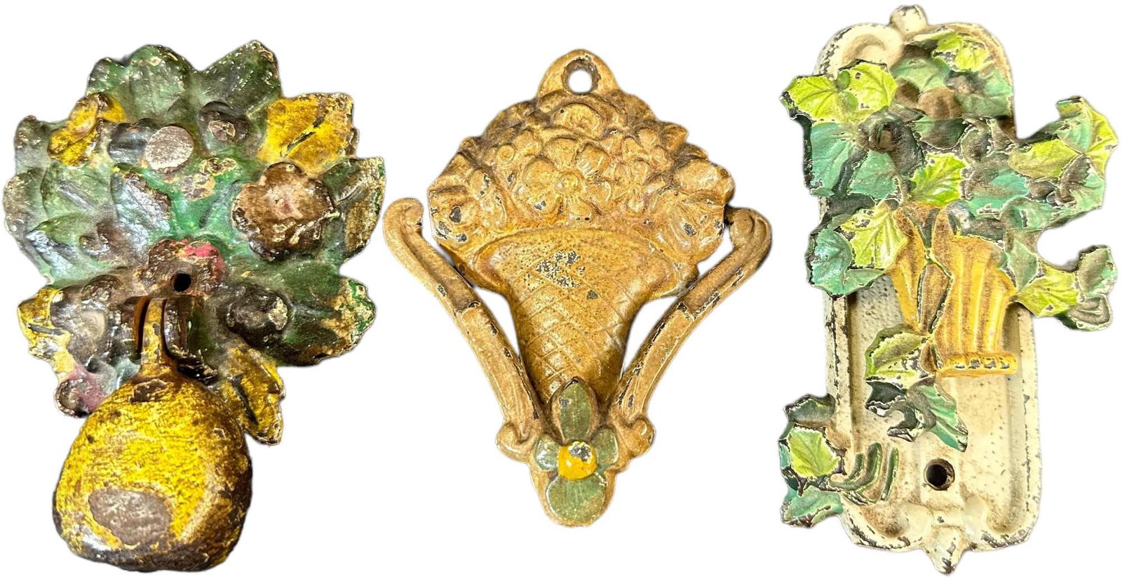 THREE COLORFUL CAST IRON DOOR KNOCKERS: 469. THREE COLORFUL CAST IRON DOOR KNOCKERS | 4.5" h. | (Very Good to Excellent Condition) | $150 - $300