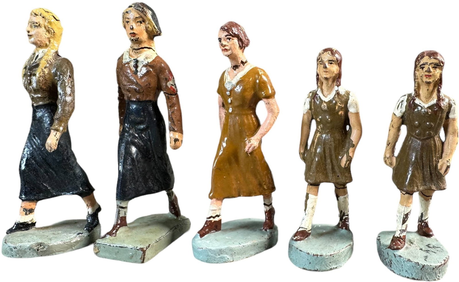 LINEOL & ELASTOLIN BDM FIGURES: 152. LINEOL & ELASTOLIN BDM FIGURES | Five very rare composition BDM (female Hitler youth) lot, includes Four Elastolin and one Lineol figure. | 65 mm | (Very Good Condition) | $250 - $500