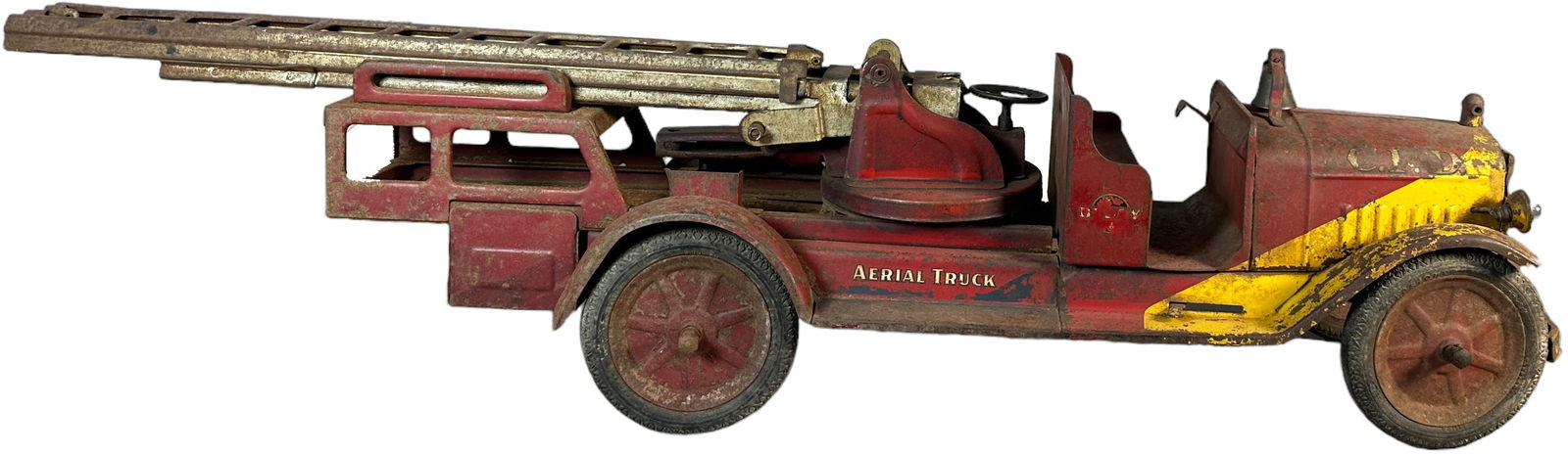 BUDDY L RIDE ON 1934 AERIAL LADDER TRUCK: 457. BUDDY L RIDE ON 1934 AERIAL LADDER TRUCK | 38" l. | Missing pull cord and seat, otherwise an original truck with heavy oxidation to paint, (Good to Very Good Condition) | $300 - $600