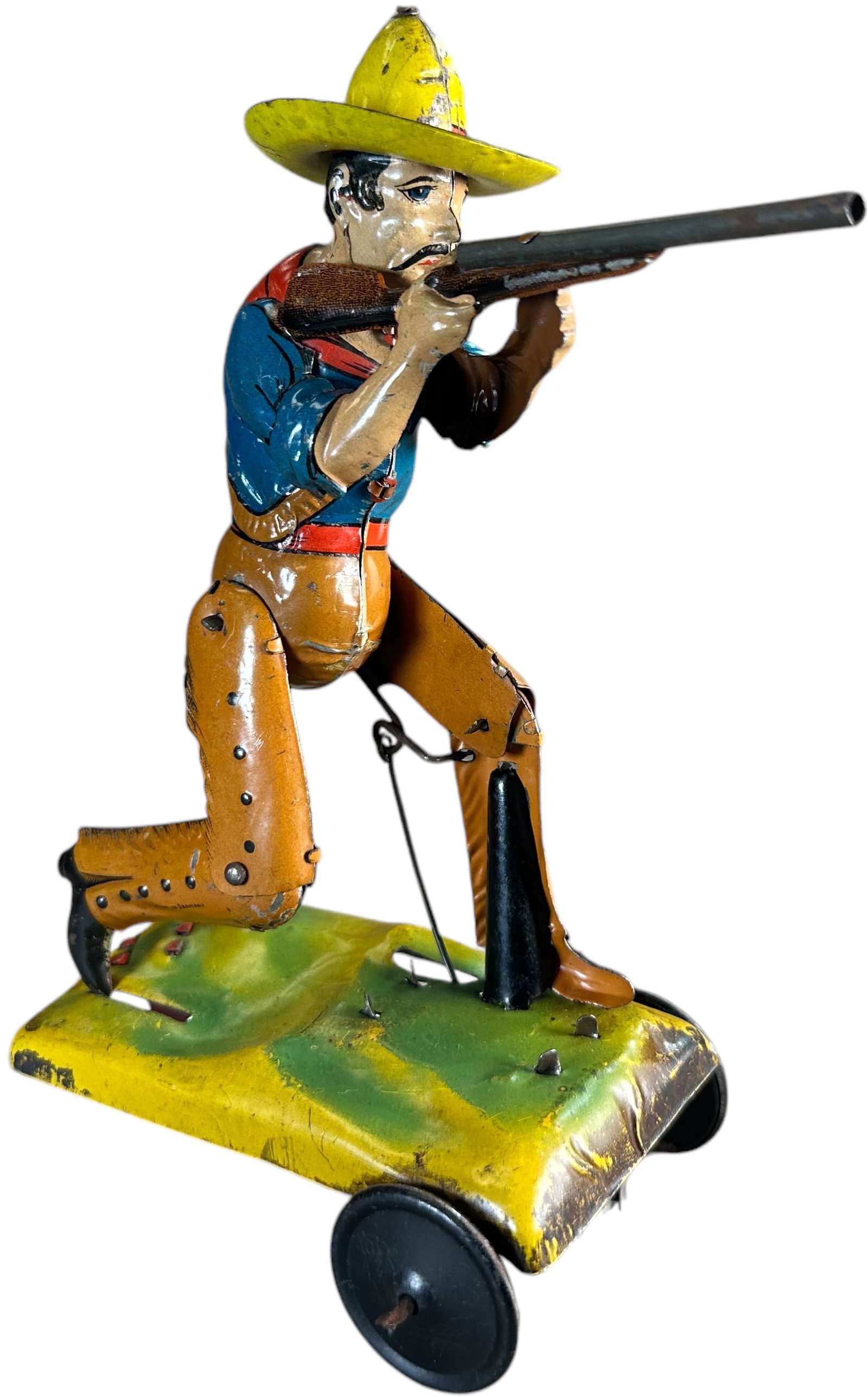 ISSMAYER KNEELING MEXICAN BANDIT: 248. ISSMAYER KNEELING MEXICAN BANDIT | Rare piece, circa 1910., multiple motions cause bandit to take a knee and shoot rifle as toy rolls. | 7" h. | Colorful original lithography, (Excellent Conditio