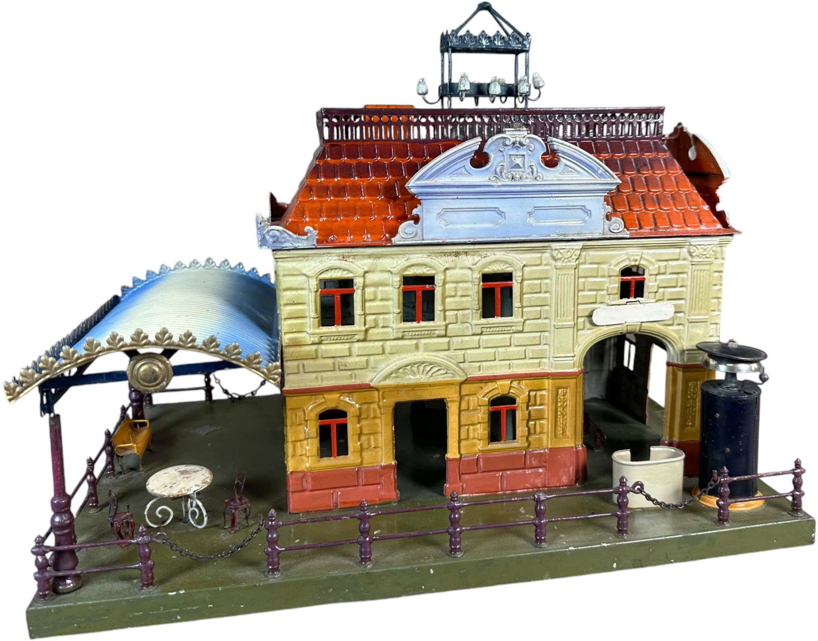 EARLY BING NO.13175 STATION WITH CANOPY: 380. EARLY BING NO.13175 STATION WITH CANOPY | Colorfully hand painted, catalog no.13175, circa 1912. | 17" l. | Minor touchup to chips and small scratches throughout building and base, overall (Excel