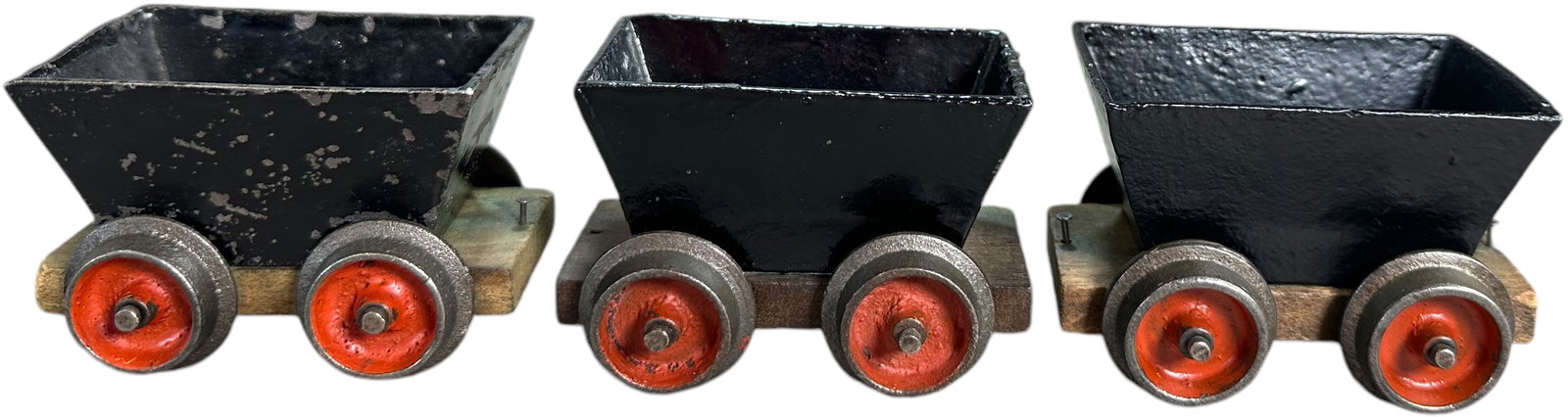 EARLY CARLISLE AND FINCH ORE CARS: 483. EARLY CARLISLE AND FINCH ORE CARS | 2" gauge, cast iron fixed bucket cars with wooden frames, two appear to be earliest type with iron strap at bottom of bucket, other car has iron ears. Circa 18