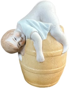 RESTING BABY ON BARREL STILL BANK