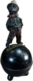 BOY SMOKING ON FOOTED BALL SPELTER BANK