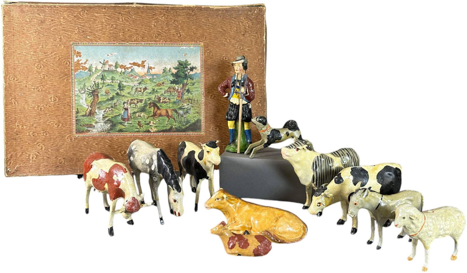 BOXED PUTZ ERZGEBIRGE SHEPHERD W/ ANIMALS: 337. BOXED PUTZ ERZGEBIRGE SHEPHERD W/ ANIMALS | 4.5" l. cow. | Some tape on side flaps, very minor glue cracks, otherwise (Excellent to Pristine Condition) | $300 - $500