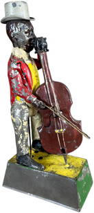 GUNTHERMANN MINSTREL W/ CELLO: 63. GUNTHERMANN MINSTREL W/ CELLO | Germany, wind-up driven. Man bows his cello as his hat dances on his head and music emits from the base when activated. | 11" h. | Wind-up is working well with nice