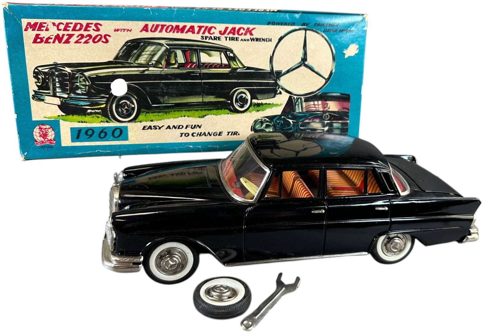 BOXED CRAGSTAN MERCEDES 220S W/ LIFTING JACK: 25. BOXED CRAGSTAN MERCEDES 220S W/ LIFTING JACK | Japan, working friction driven motor. | 11.5" l. | Box in (Excellent Condition toy in (Pristine Condition) | $150 - $300