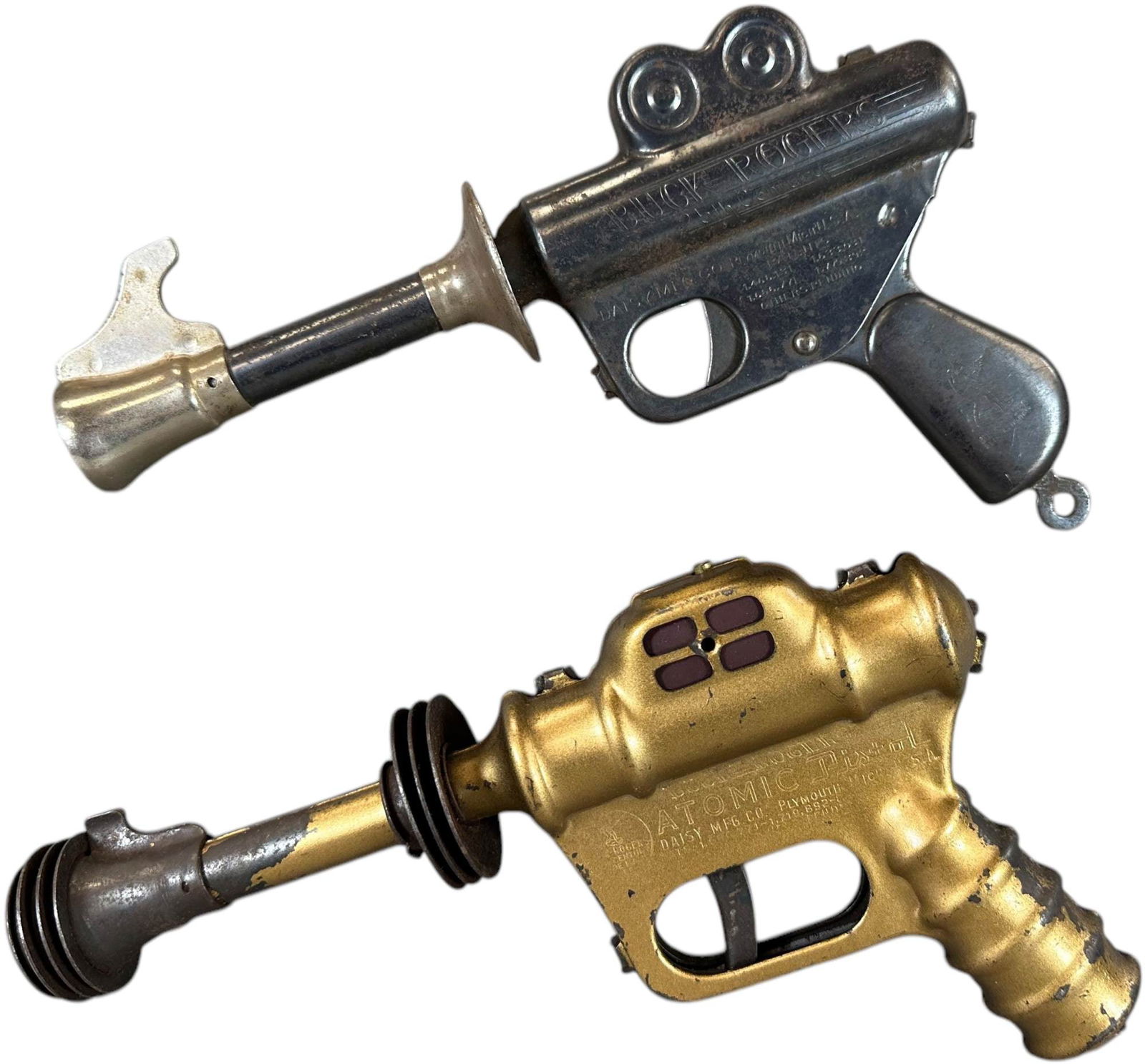 TWO DAISY BUCK ROGERS ATOMIC SPACE PISTOLS: 54. TWO DAISY BUCK ROGERS ATOMIC SPACE PISTOLS | 10" l. | (Very Good to Excellent Condition) | $100 - $200