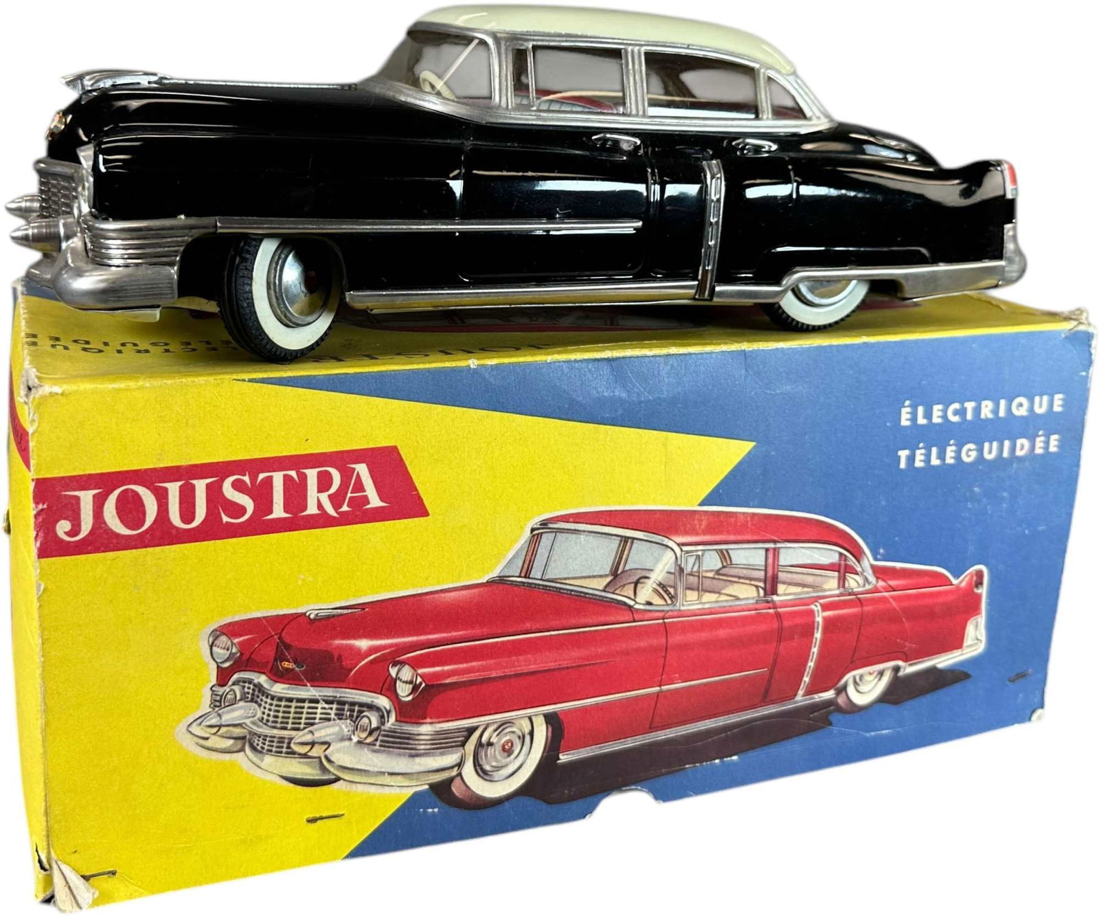 BOXED JOUSTRA 954 CADILLAC BATTERY-OP: 97. BOXED JOUSTRA 954 CADILLAC BATTERY-OP | France, battery-op. Remote control wire is broken. Ex: Ira Bernstein Collection. | 12.5" l. | Includes original remote and box insert, original windows, a l