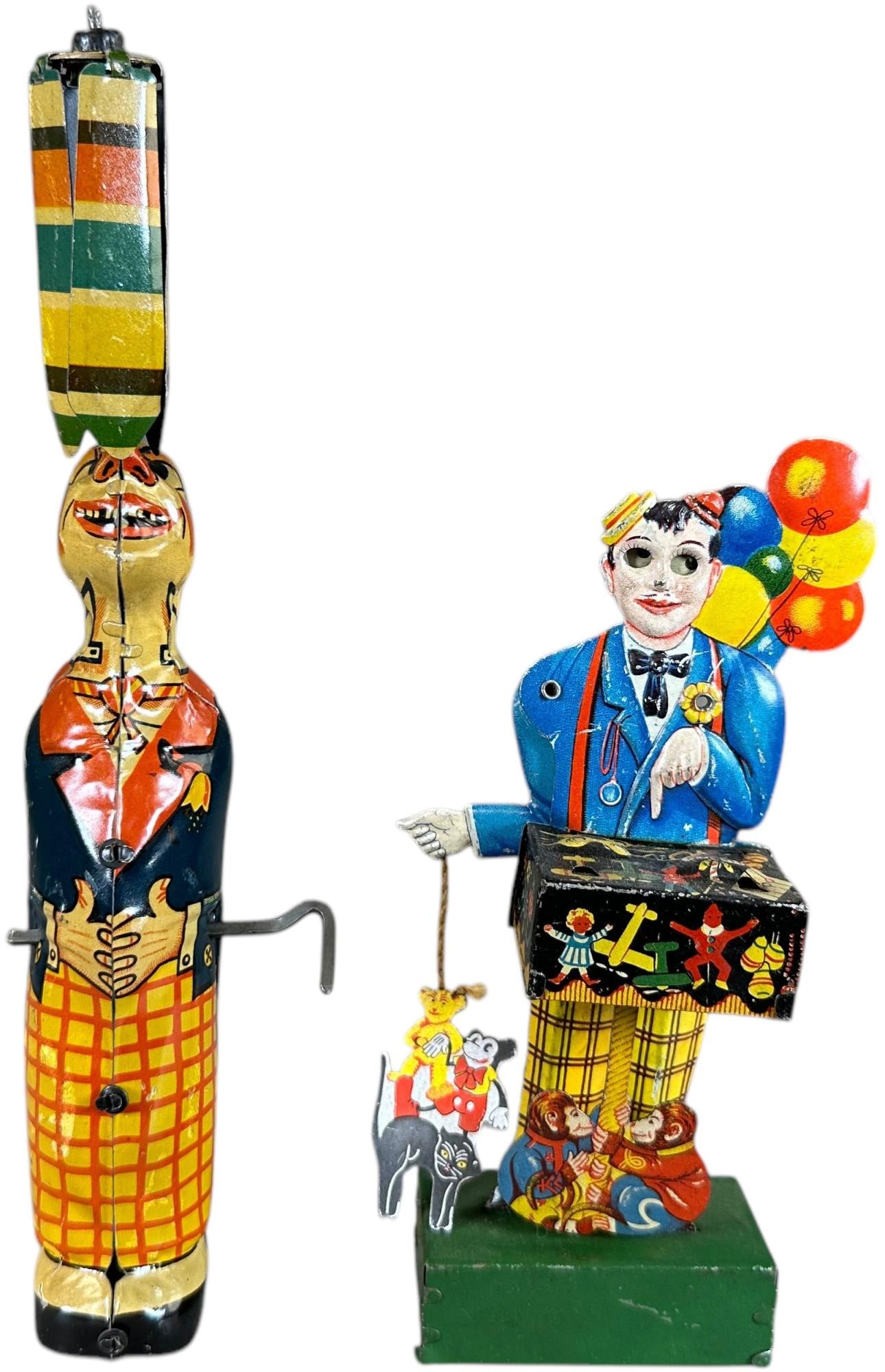 EINFALT BALLOON VENDOR W/ GELY CLOWN UMBRELLA: 269. EINFALT BALLOON VENDOR W/ GELY CLOWN UMBRELLA | Germany, wind-up motor. | 9.5" h. | Clown vendor holds a replacement Mickey figure, otherwise both toys are clean (Excellent to Pristine Condition)
