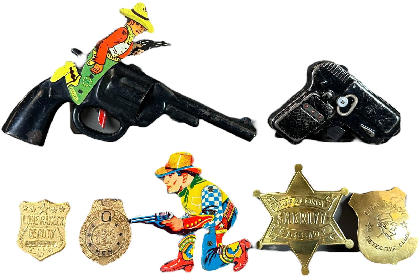 ASSORTED WESTERN CAP GUNS ITEMS: 402. ASSORTED WESTERN CAP GUNS ITEMS | Rare Lone Ranger Deputy Badge has secret compartment and was a cereal company give away. | 8" l. | Overall (Excellent Condition) | $50 - $100