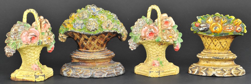 FOUR FLOWER & FRUIT BASKET BOOKENDS / DOORSTOPS: One set of Hubley handled flowers. Fruit basket is Book Example in Smith Book. Approx. 5 1/2" h.