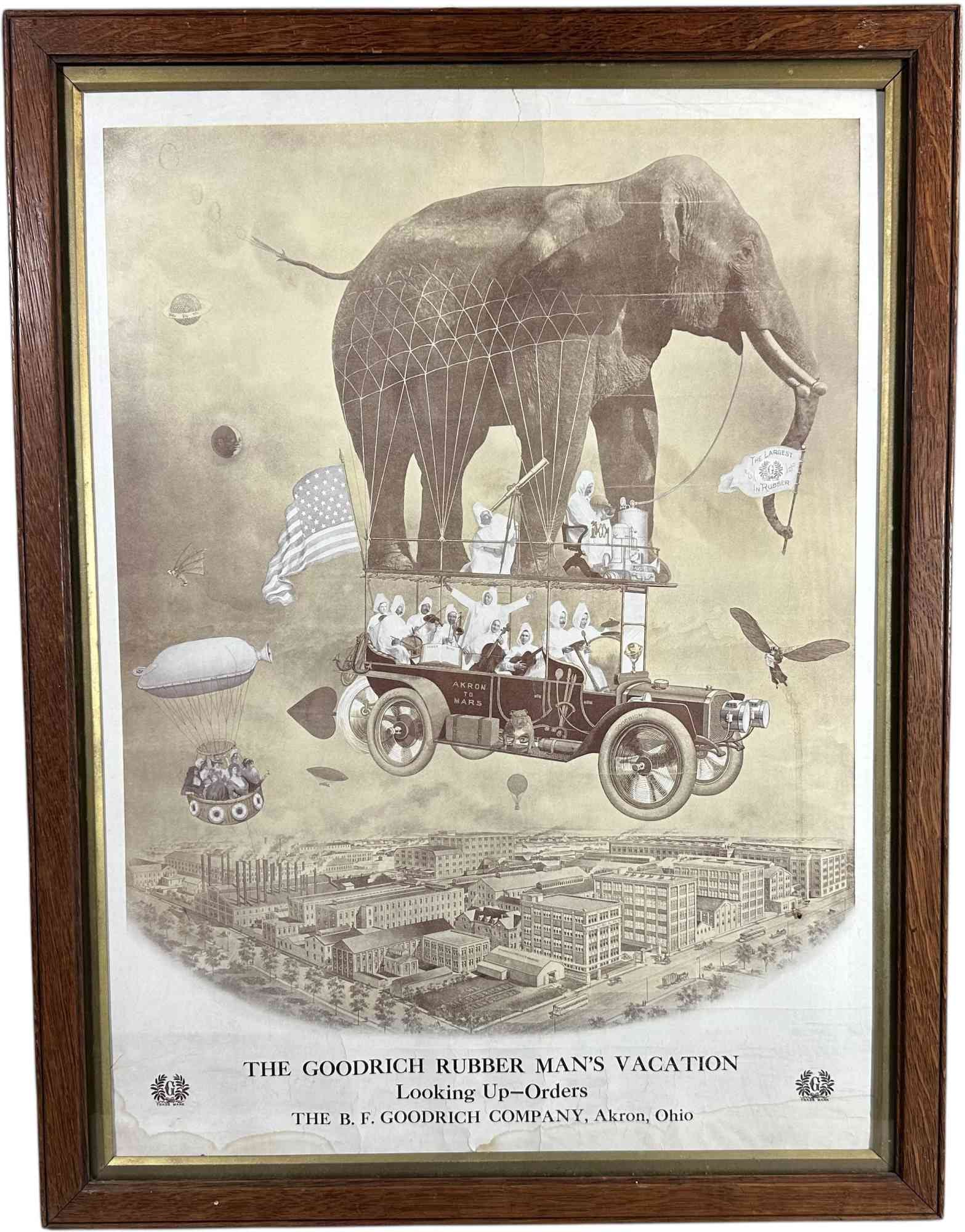 FRAMED BF GOODRICH AIRSHIP ADVERTISING POSTER: 168. FRAMED BF GOODRICH AIRSHIP ADVERTISING POSTER | Great imagery of whimsical airships in background with an Akron to Mars auto lifted by an elephant/balloon. Behind glass in wooden frame. From the 
